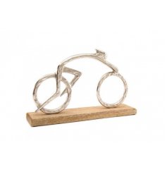 A minimalistic inspired cycling ornament set upon a natural wood base 