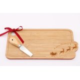 A simple wooden cheeseboard, featuring a curved shape edging and embossed Christmas scene 
