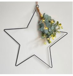 A contemporary inspired hanging wire star decoration with added lights,