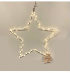 A sleek and simple extra large white wire star entwined with warm glowing LED Lights 