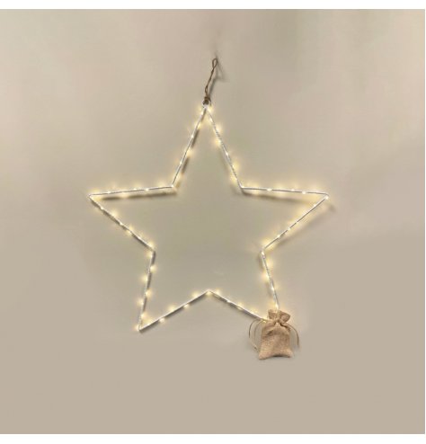 An extra large white metal wire star shape with fine LED lights woven around. 