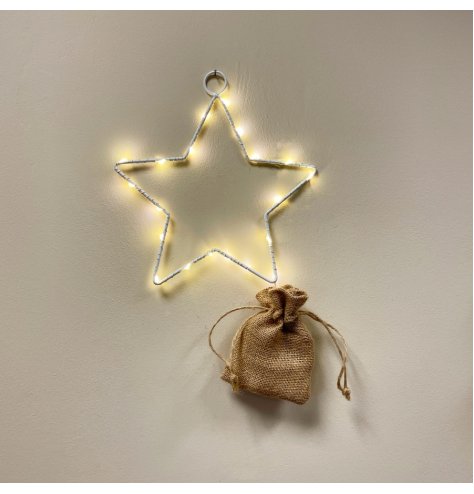 A white metal wire star shape with fine LED lights woven around. 