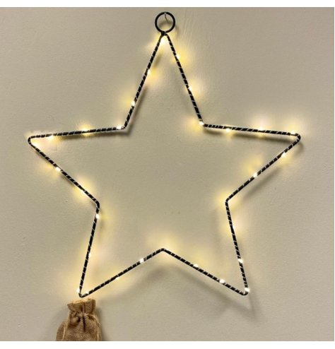 A Black metal star shape with fine LED lights woven around. 