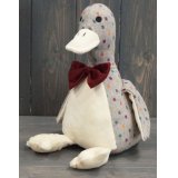 A delightful little sitting duck doorstop made from a grey and multi toned spotted fabric 