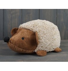  A hedgehog themed doorstop decorated with fluffy trimmings and a soft to touch body 