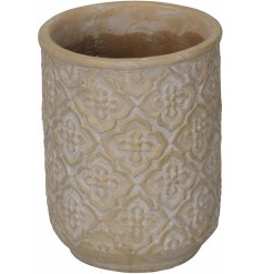 An overly distressed inspired concrete pot with a terracotta colouring and floral embossed patterning 