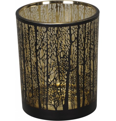 A gold lined glass t-light holder with an etched woodland tree decal across the front 