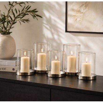 A sleek and simple themed candle holder with assorted sized glass cylinder inserts 