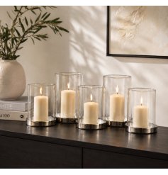 A sleek and simple themed candle holder with assorted sized glass cylinder inserts 