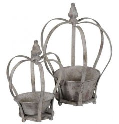 An assorted sized set of overly distressed metal crown planters, perfect for sprucing up your garden spaces! 