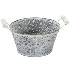 A small zinc planter featuring an embossed star decal, white washed finish and natural wooden handle 