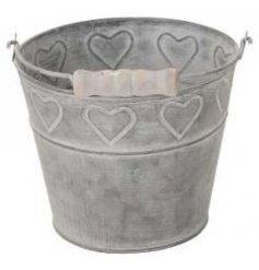 A rustic looking bucket complete with a chunky wooden handle and embossed heart motif surrounding it 
