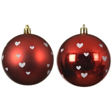 An assortment of shatterproof bauble set with shiny and matt red tones and little white hearts to finish each 