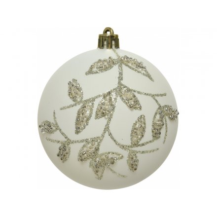 A white toned glass bauble beautifully set with a glittery beaded leaf pattern surrounding it 