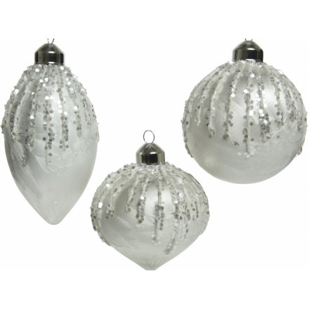 A mix of 3 shaped glass baubles, each set with a white base tone and added glittery accents 