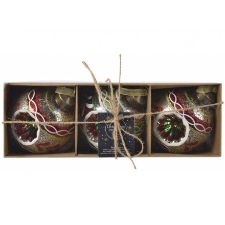 A mix of 3 indent shaped glass baubles, each covered with its own traditional colours and patterns 