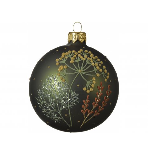 A green hued glass bauble decorated with a stunning floral glitter pattern 