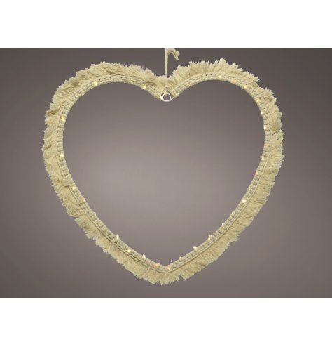 A minimalistic inspired macrame heart with added warm glowing LED accents, a stunning accessory to bring to a Boho setti