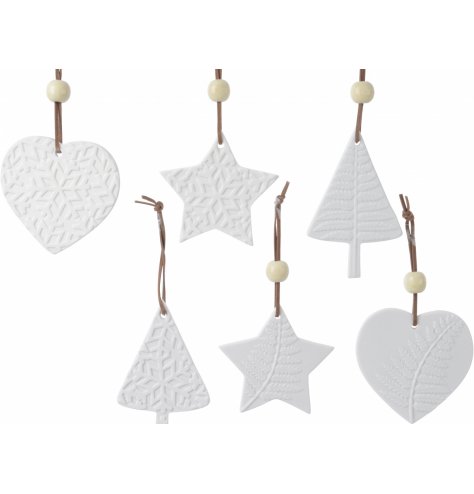 A mix of ceramic white hanging decorations with a variety of prints and shapes 