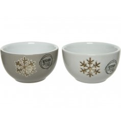 A sleek assortment of porcelain bowls, each embossed with a charming gold toned snowflake decal 