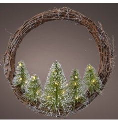 a large willow wrapped wreath combined with frosted trees and LED lights 