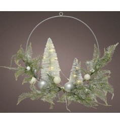 A wire based wreath, beautifully decorated with artificial foliage, baubles, glittery trees and warm glowing LED Light 