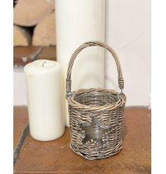  A woven wicker candle lantern set with a shaped star central window and added handle to feature