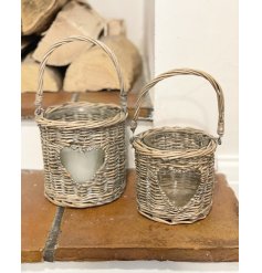  Sure to bring a Country Charm feel to any space of the home, a woven wicker candle holder with a small heart window 