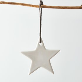 A simple white toned ceramic star hanging decoration complete with a black string for an added features