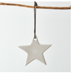 A simple white toned ceramic star hanging decoration complete with a black string for an added features