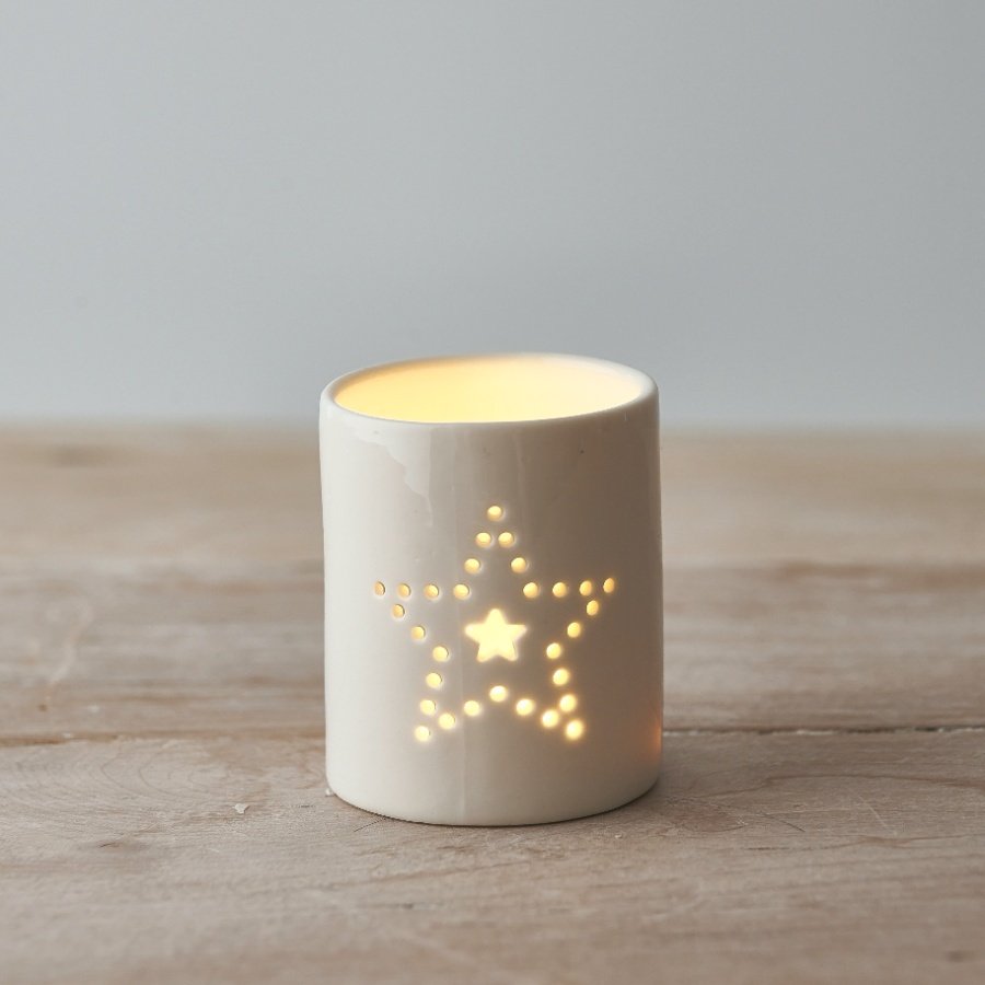 A ceramic tlight holder complete with a smooth white glaze look and dotted star decal 