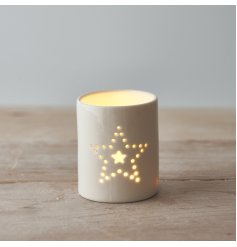 A ceramic tlight holder complete with a smooth white glaze look and dotted star decal 