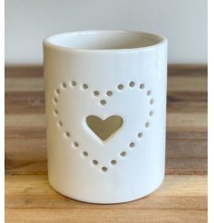 A sleek and simple ceramic tlight holder with a small sotted heart decal to complete its look 