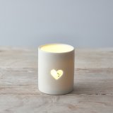 A sleek and simple ceramic tlight holder with a small heart cut decal to complete its look 