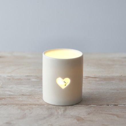  A ceramic tlight holder complete with a smooth white glaze look and heart cut decal 