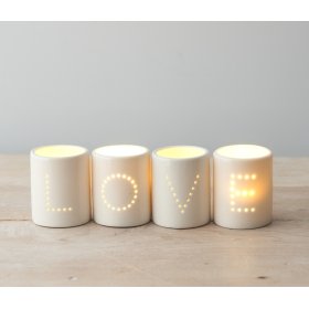 A Set of Four 'LOVE' White Ceramic T-Light Holders