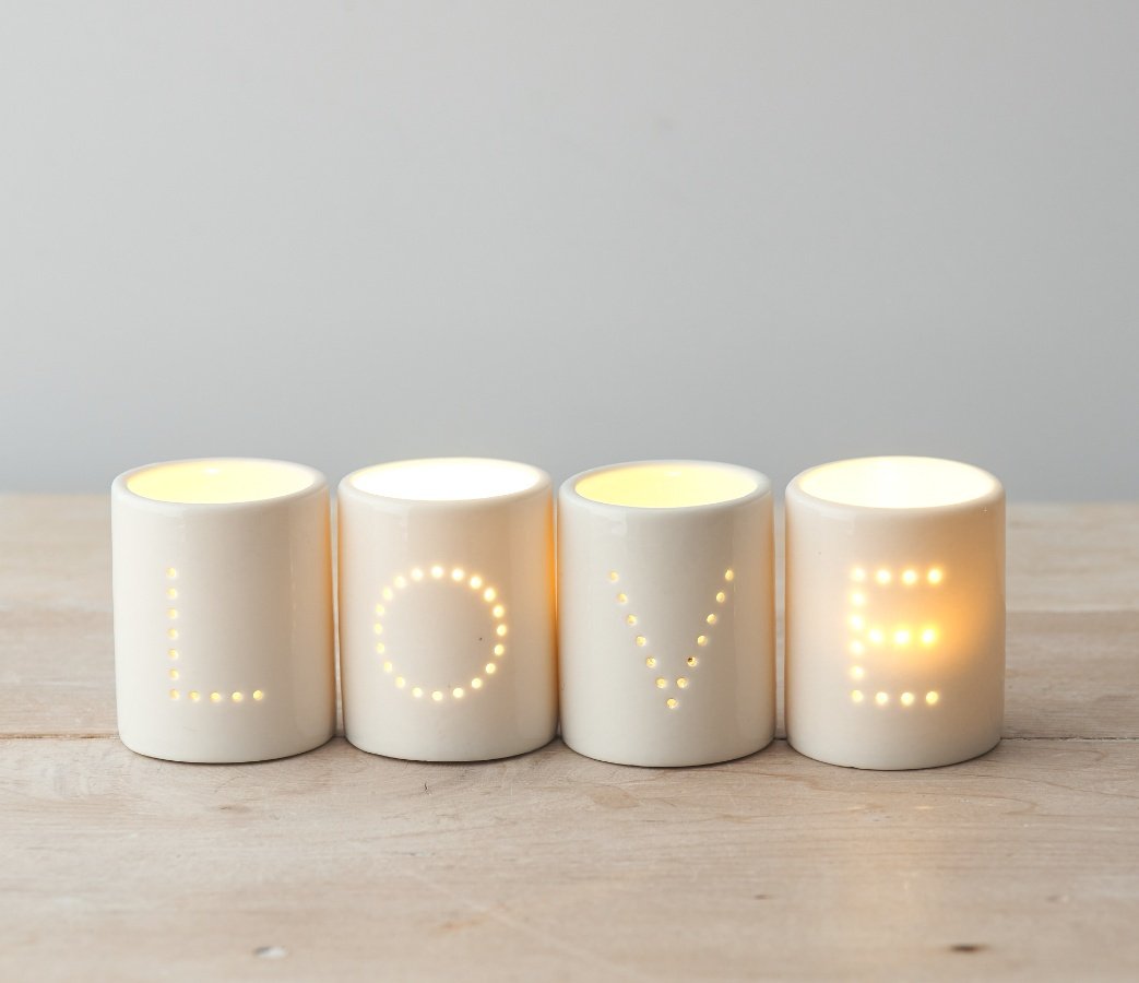 A Set of Four 'LOVE' White Ceramic T-Light Holders