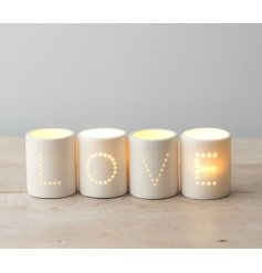 A Set of Four 'LOVE' White Ceramic T-Light Holders