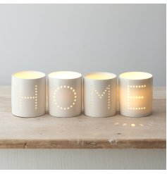 A sleek and simple set of white ceramic tlight holders, each complete with a pin dot HOME text decal 