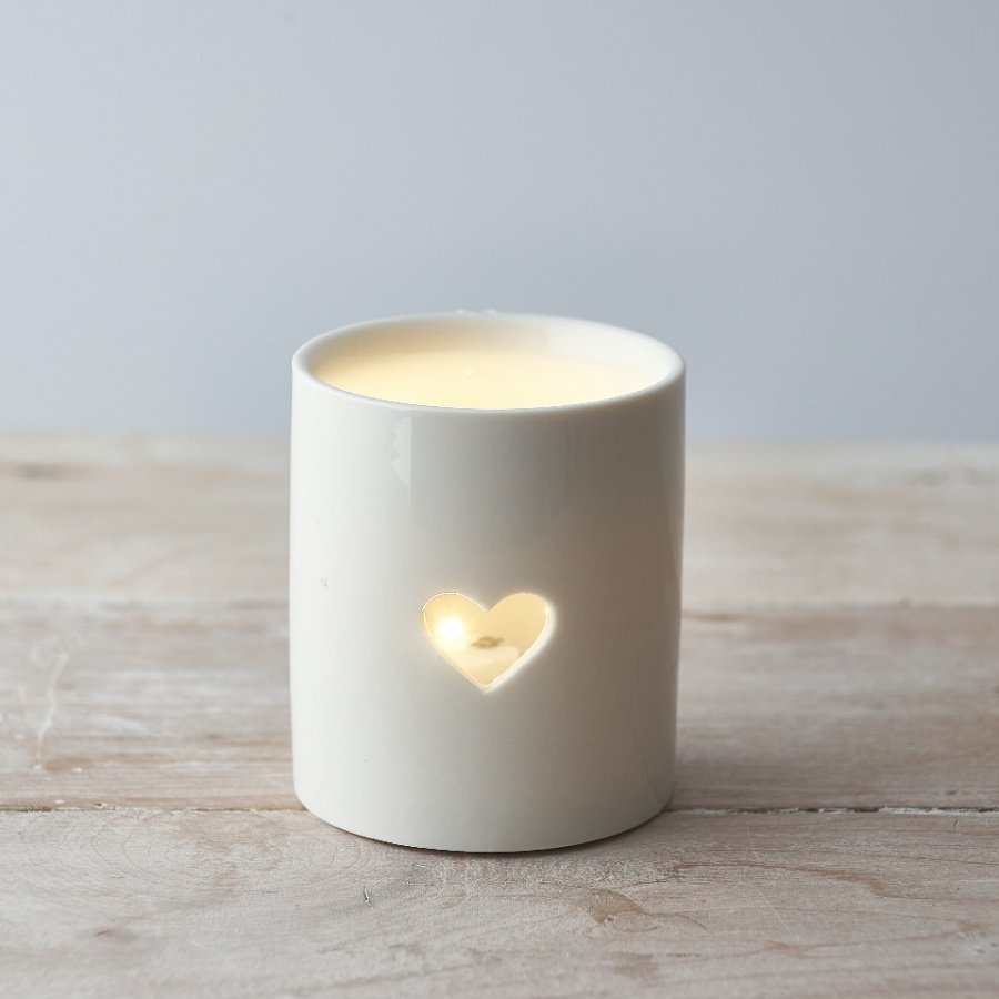 A sleek and simple ceramic tlight holder with a small heart cut decal to complete its look 