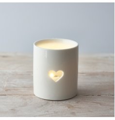A sleek and simple ceramic tlight holder with a small heart cut decal to complete its look 