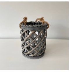   A tall rounded lantern featuring a lattice willow decal and chunky rope handle 