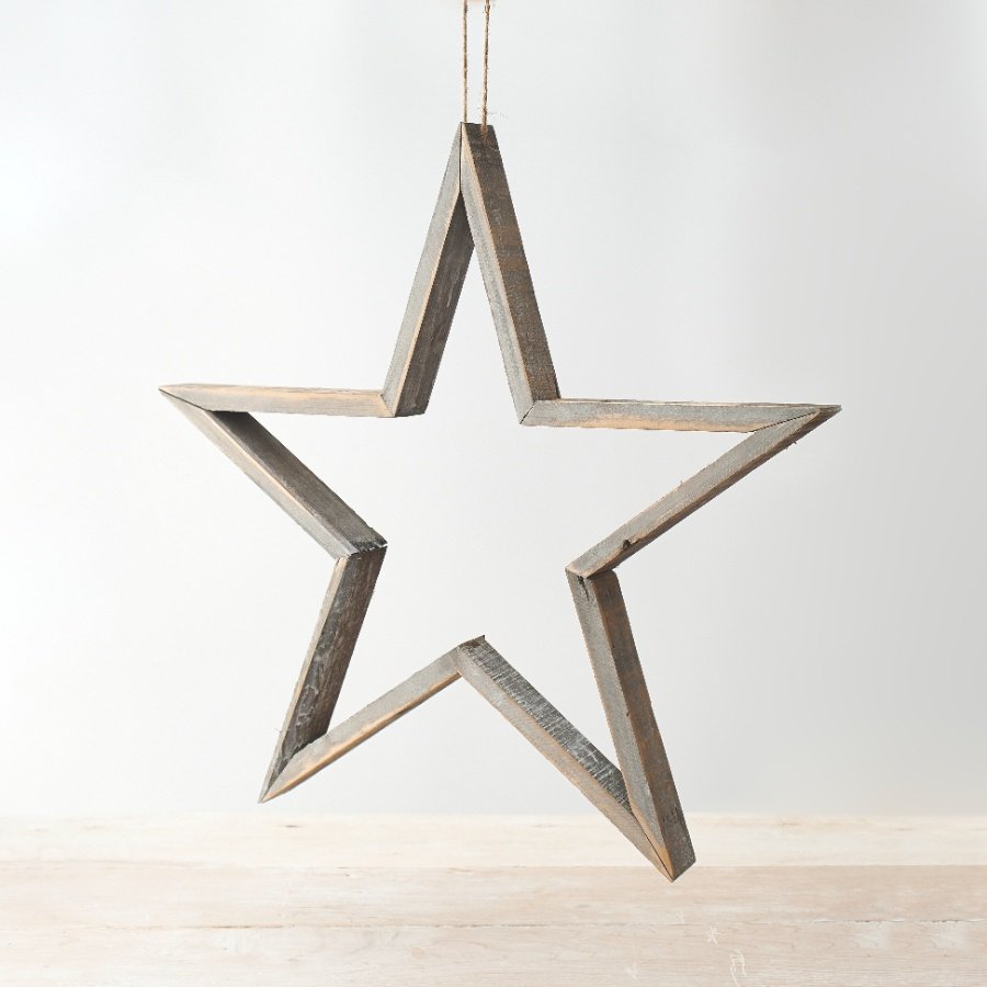 A rustic wooden star decoration with a grey washed finish and jute rope hanger.