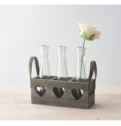a wooden tray with heart cut windows and 3 long neck bottles 