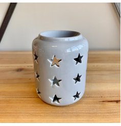  A tall standing ceramic based tlight holder featuring a dipped top and star cut 
