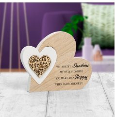  A charming natural wooden heart with an added heart shaped puzzle piece in a white tone and scripted text decal 