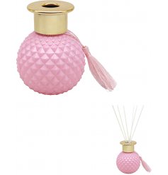 A pretty pink toned Diffuser bottle set with a gold cap, diamond ridge edging and charming vintage tassel to complete th