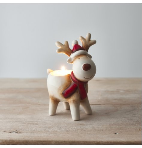 A brown and red toned ceramic reindeer tlight holder 