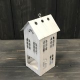 A rustic white t-light holder with cut out detailing and hook.