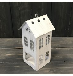An overly rustic inspired metal house shaped tlight holder 